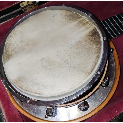 133 - A George Formby Banjo Ukulele in a wooden case, in need of some restoration, skin a.f.