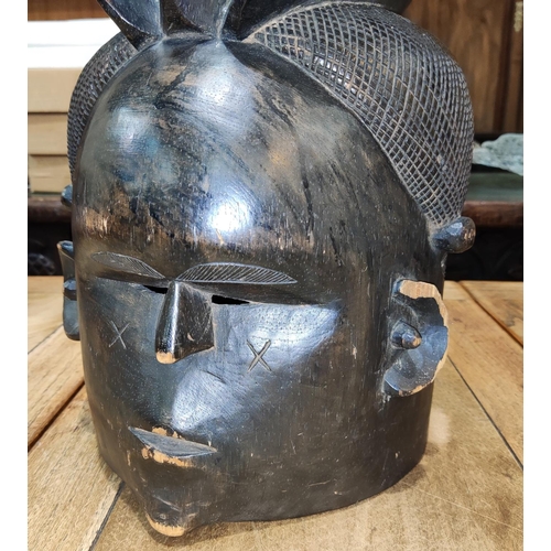 157 - A late 19th/early 20th century carved African tribal wooden head dress with integral face mask with ... 