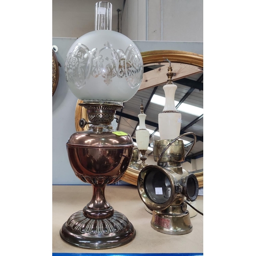 18 - A copper oil lamp with etched shade and  
