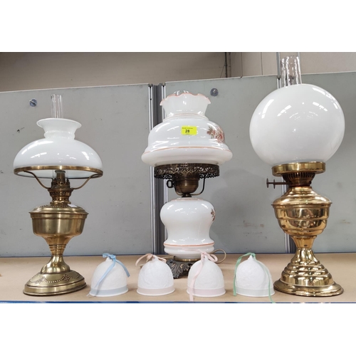 28 - Two reproduction brass oil lamps; a similar glass table lamp; 4 Lladro bells