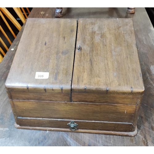 335 - An Edwardian walnut slope front correspondence box with a double hinged top.