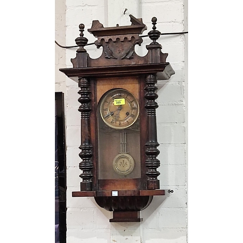 355 - A spring driven Vienna wall clock in a stained mahogany case.