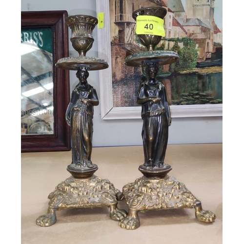 40 - A pair of candlesticks with bronze classical figure columns, square embossed bases on paw feet, heig... 