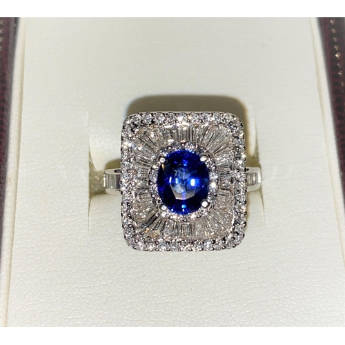 649 - An 18ct white gold Art Deco style dress ring set with an oval sapphire in rectangular 3 tier setting... 