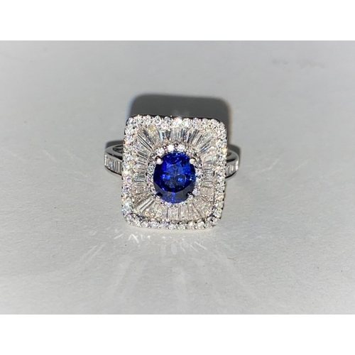 649 - An 18ct white gold Art Deco style dress ring set with an oval sapphire in rectangular 3 tier setting... 