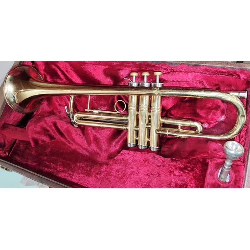 135 - An American Conn cased brass trumpet with mother of pearl inlaid buttons No. K96203