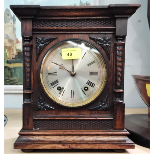 48 - An architectural oak cased striking mantel clock