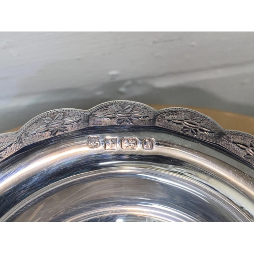 618 - A hallmarked silver scalloped circular bowl with engraved border and circular foot, Birmingham 1962,... 