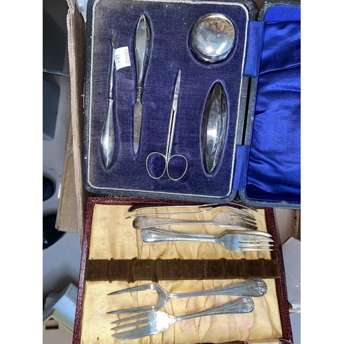 681 - A silver manicure set, cased, Birmingham 1919; a 3 piece embossed dressing table set, Birmingham 190... 