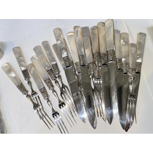 690 - A set of 12 dessert knives and forks with mother-of-pearl handles; a set of 12 silver plated fish kn... 