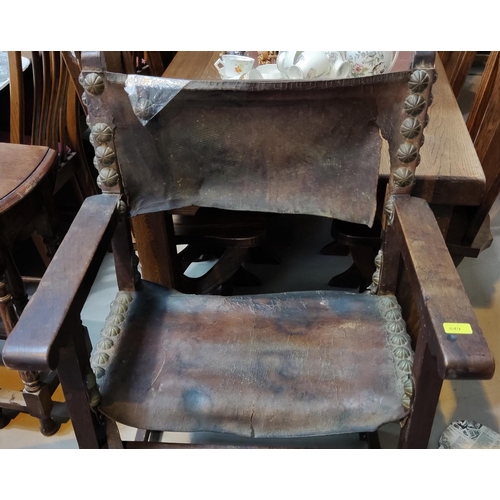 849 - An antique Armada Chair armchair with later leather studded seat and back (some leather a.f)