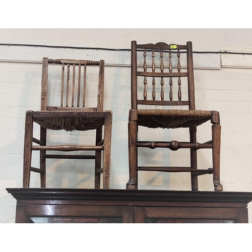 853 - A 19th century elm Lancashire spindle back rush seat dining chair and a similar chair