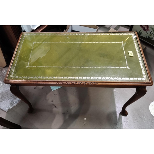 885 - A reproduction mahogany coffee table with green leather top , with glass protector to top