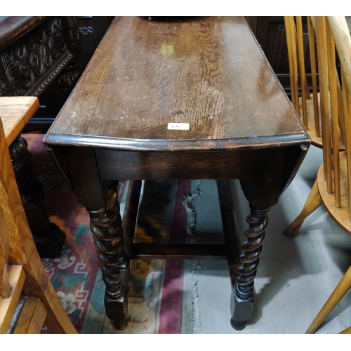 892 - An oak barley twist drop leaf table of oval form length 102cm