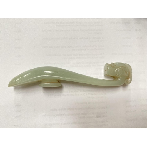 415A - A Chinese jade coloured hardstone carving of a dragons head with an elongated neck on wooden stand, ... 