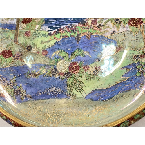 518 - A Wilton ware shallow bowl with gilt and lustre chinoiserie landscape scene, trees, flowers and rive... 