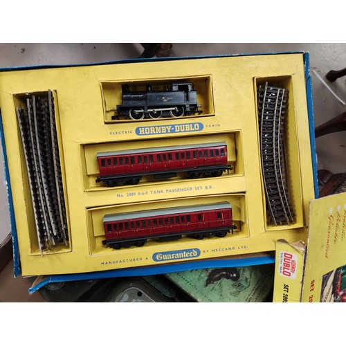 228A - A Hornby boxed set of tin plated passenger train and a selection of boxed vintage dublo gauge track ... 