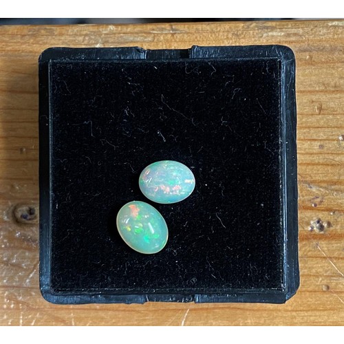 719 - Two cabochon cut opals, 2.2 carats