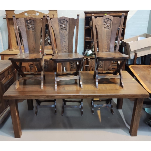 828 - An oak period style dining suite, the table with heavy plank top and square legs, 6 chairs with shie... 