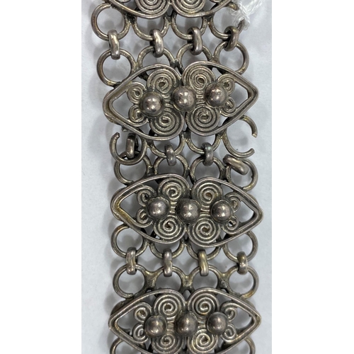 626 - An oriental white metal (silver) belt with chain links and scroll work decoration, can be fastened t... 