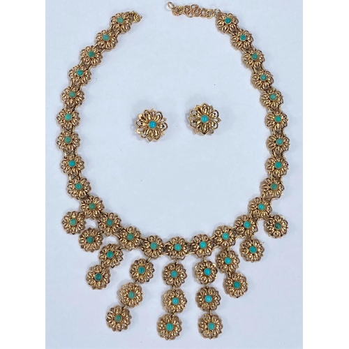 640 - A yellow metal necklace and earring set, each link in the form of a flowerhead mounted with central ... 
