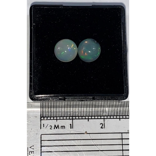 649 - Two round cabochon cut opals, 1.65carats gross