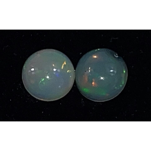 649 - Two round cabochon cut opals, 1.65carats gross
