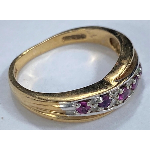 657 - A 9 carat hallmarked gold ring with rubies and diamonds in crossover setting, 3.2 gm