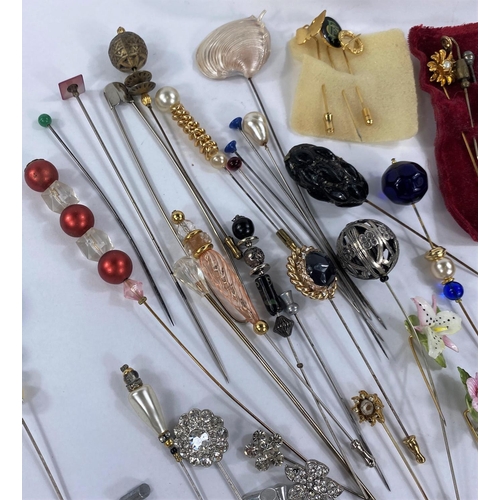 714 - A good selection of vintage stickpins and hat pins