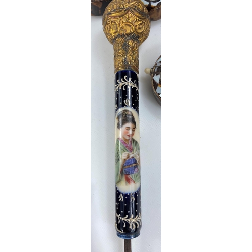 92 - A porcelain umbrellas handle with ormolu terminal and reserve panels of young women; miniature torto... 