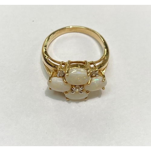 631 - A 9 carat hall marked gold ring set with 4 opal coloured stones and 5 diamond simulants 4.5cm