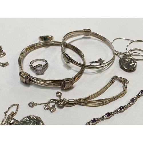 633 - A selection of white metal bracelets, rings, lockets etc