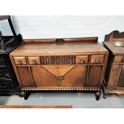 911 - A 1930's oak sideboard, 3 drawers and double cupboard under