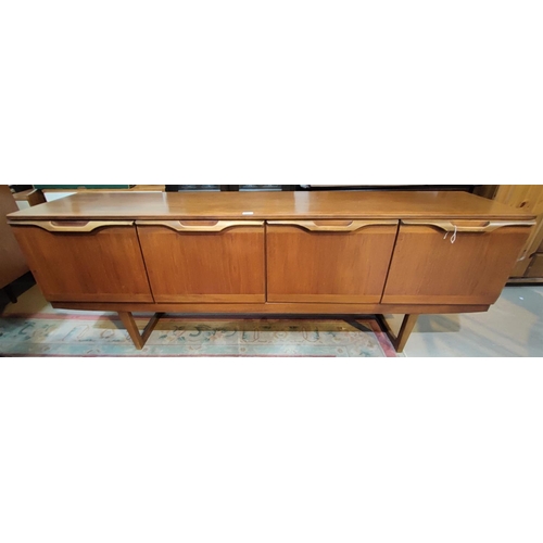 864 - A 1960's teak lowline sideboard with 4 cupboards, by Stonehill