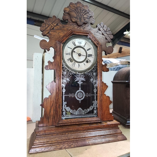 139 - An oak cased wall clock 