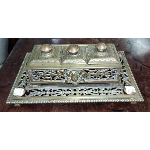 60B - A 19th century brass double desk set with inkwells and central stamp section under hinged lids with ... 