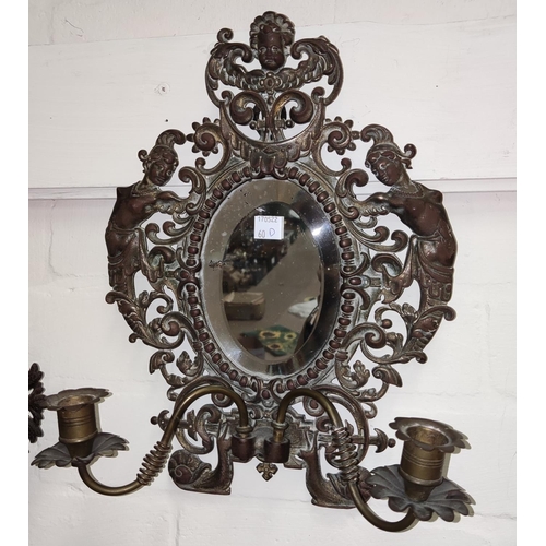 60D - A bronzed and gilt mirror double candle wall sconce decorated with figures and pierced areas, height... 
