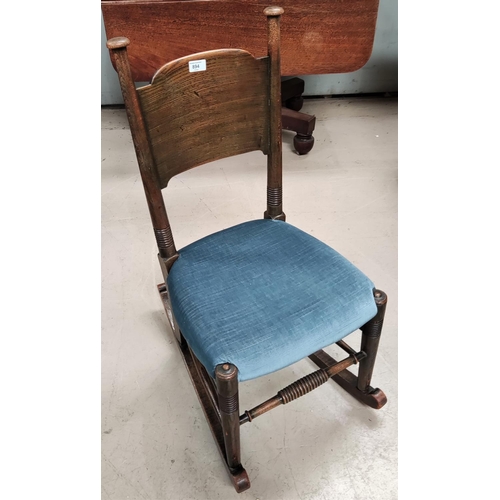 894 - An Arts and Crafts oak rocking/nursing chair