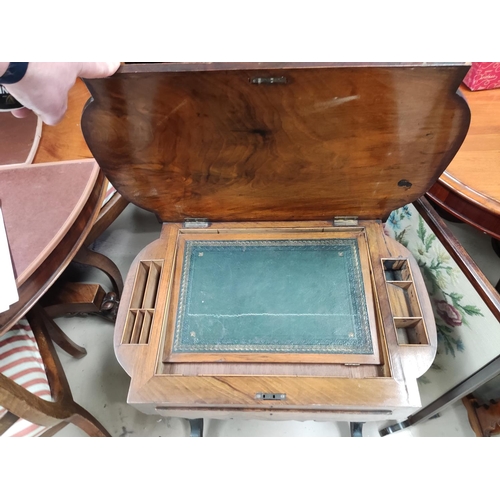 840 - A Victorian quarter veneered walnut worktable with hinged rounded rectangular top, writing slide and... 
