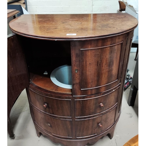 866 - A 19th century mahogany demi-lune commode with hinged top, double doors, false fascias, and original... 