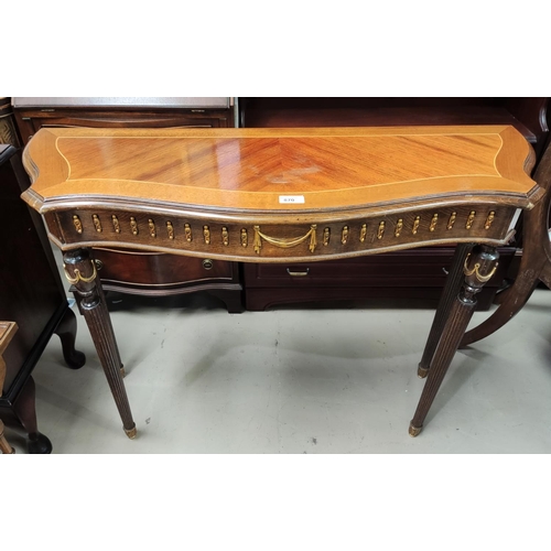 870 - A reproduction quarter veneered Serpentine front side table with gilt metal mounts