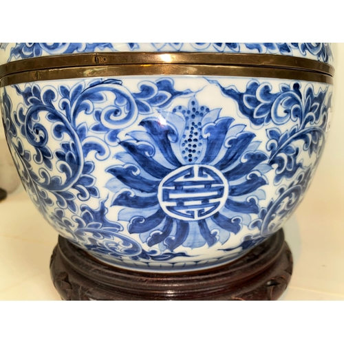 405E - A Chinese blue and white lidded bowl decorated with vines etc, with brass bindings around rims 25.5c... 