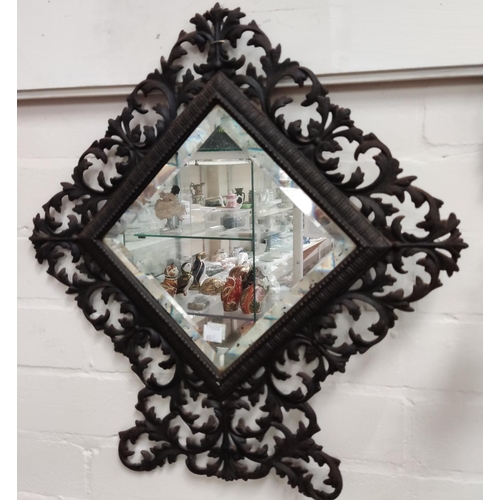 60C - A wrought metal pierced framed bevelled edge wall mirror height 47cm