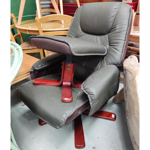 848 - A reclining chair and matching footstool in green leatherette