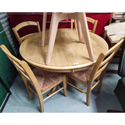 857 - A lightwood kitchen dining suite comprising pedestal table with circular top and 4 chairs with rush ... 