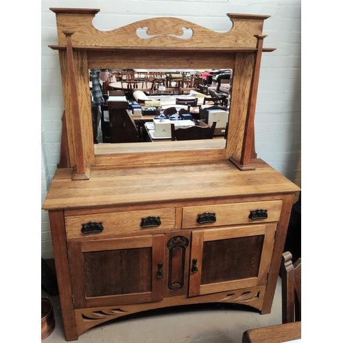 863 - An Arts & Crafts oak sideboard with mirror back, square pillars, 2 side cupboards and 2 drawers