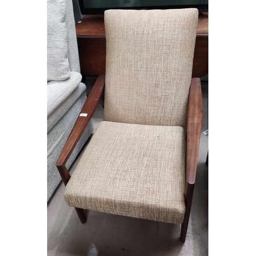 919 - A 1960's pair of armchairs by Guy Rogers upholstered in oatmeal fabric