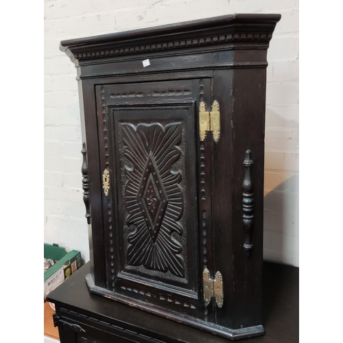 831 - A 19th century carved oak corner cupboard with straight front; a similar firescreenNo bids sold with... 