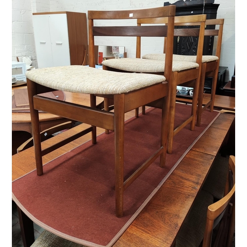916 - A 1960's teak dining suite comprising rectangular extending table, ex. length 211c, and a set of 8 l... 