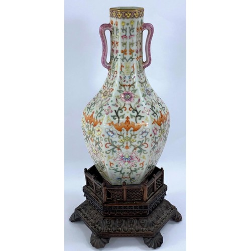 435 - A Chinese porcelain vase of hexagonal baluster form with loop handles, stylised floral decoration wi... 